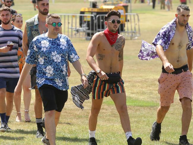 Opened-buttons shirts — or no shirts at all — were the order of the day for some men attending the Centennial Park event. Picture: Matrix