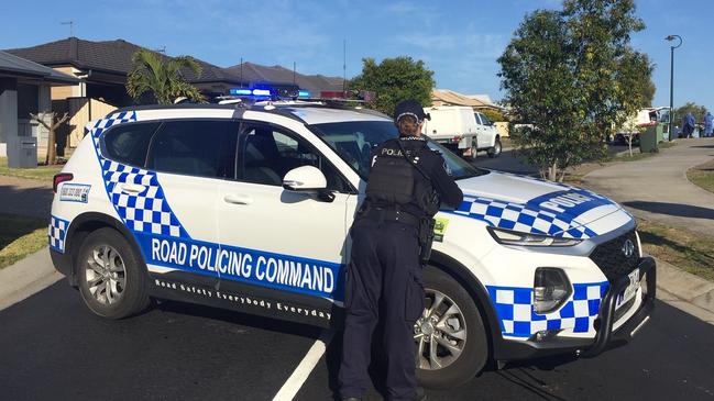 Police have closed off a road near the scene of a fatal shooting at Dakabin. Picture: John Gass.