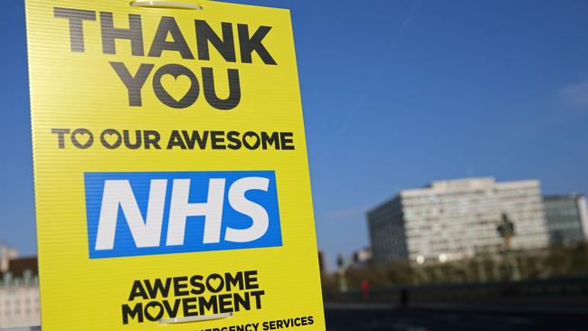 A sign thanking the NHS (National Health Service) is attached to a lamppost on Westminster Bridge with London’s St Thomas' hospital seen behind. Picture: Isabel Infantes/AFP