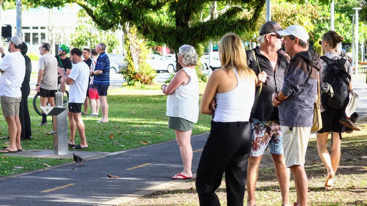 Members of the public gather as emergency crews continue investigations into the crash at the Hilton hotel on Cairns Esplanade. Picture: Brendan Radke