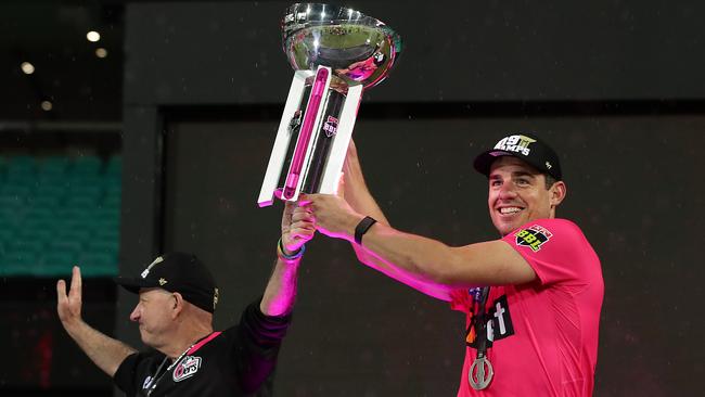 Sixers skipper Moises Henriques hoists the BBL trophy earlier this year.