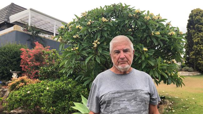 Alan Bate, 75, of Collaroy, outside the house of neighbours James and Diane Kirby. Picture: Julie Cross