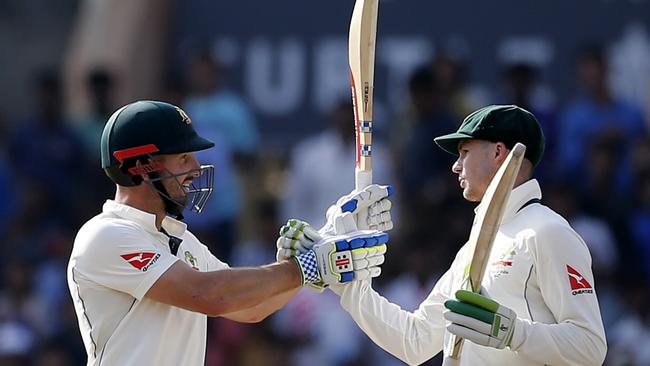 Shaun Marsh, left, celebrates his 50 with teammate Peter Handscomb.