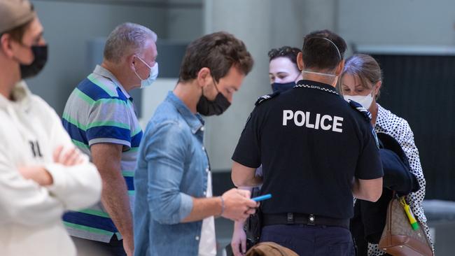 Police check border passes at the Brisbane Airport. Picture: Brad Fleet