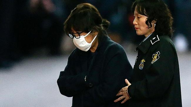 Choi Soon-Sil, the woman at the heart of a lurid political scandal engulfing South Korea's president Park Geun-Hye, is escorted following her formal arrest. Picture: AFP