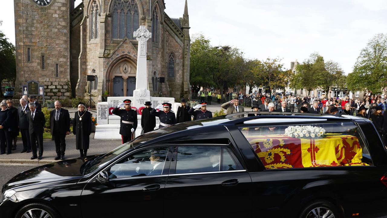 The cortege carrying the coffin of Elizabeth II passes by a crowd in Ballater. Picture: Jeff J. Mitchell/Getty Images