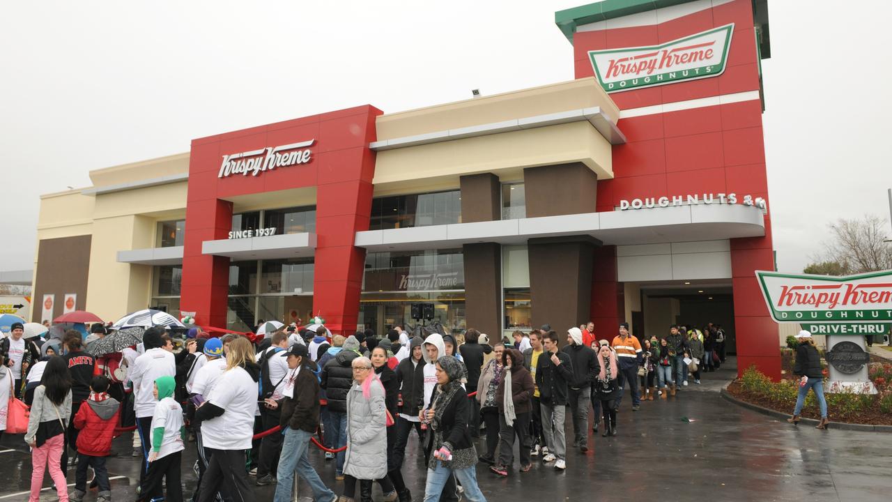 People queue in the rain for the opening of Krispy Kreme in Adelaide, 10 years ago.