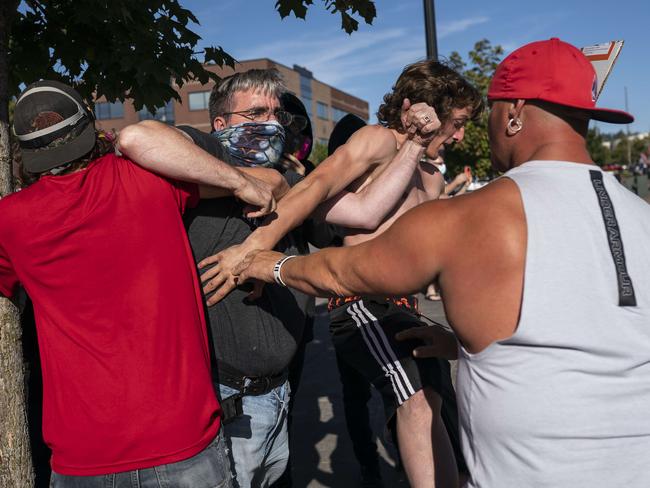 A Black Lives Matter protester scuffles with attendees of a pro-Trump rally during an event in Oregon. Picture: Getty Images/AFP