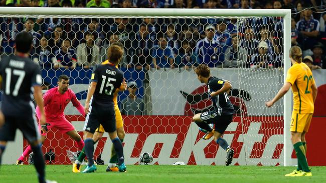 Takuma Asano (3rd R) of Japan scores the opening goal.