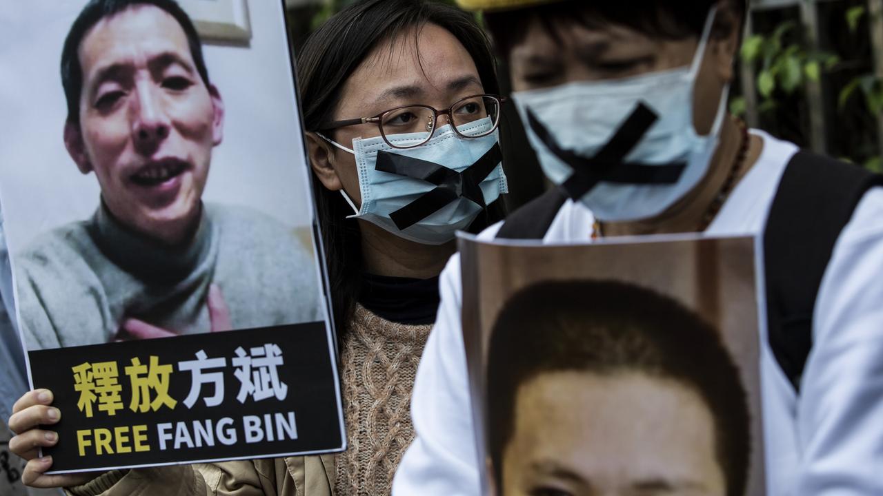 A pro-democracy activist from HK Alliance holds a placard of missing citizen journalist Fang Bin, as she protests outside the Chinese liaison office in Hong Kong on February 19, 2020. Picture: Isaac Lawrence/AFP