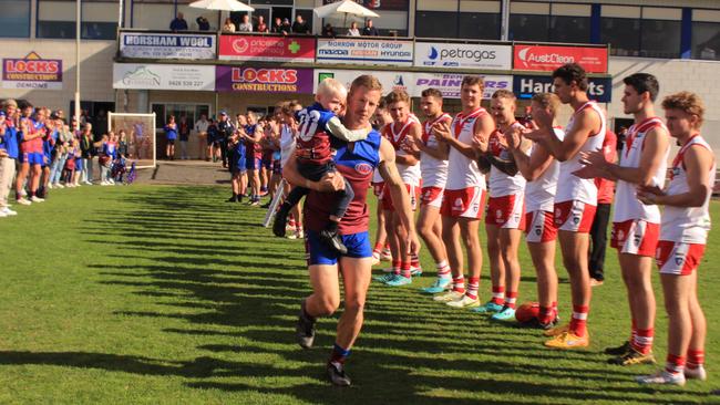 Horsham Demons and Ararat players form a guard of honour as Brad Hartigan runs onto the ground for his 300th match in the Wimmera league. Picture: Eliza McAnulty