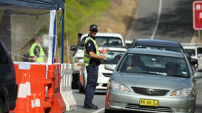 Queensland Police stop a NSW registered vehicle at the Miles Street / Ducat Street Street border checkpoint in Coolangatta Queensland for a secondary ID check as traffic backs up to Kennedy Drive in Tweed Heads NSW on Wednesday July 15. Photo Scott Powick Newscorp