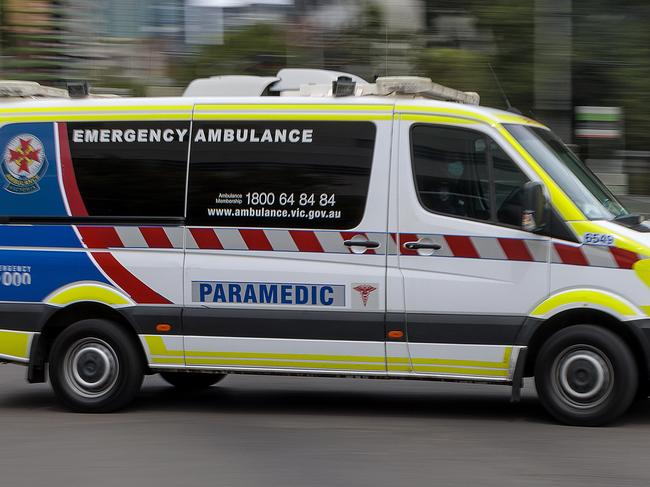 MELBOURNE, AUSTRALIA - NewsWire Photos FEBRUARY 13, 2022: An ambulance speeds away from the Royal Melbourne Hospital. Ambulance, Generic.Picture: NCA NewsWire / David Geraghty
