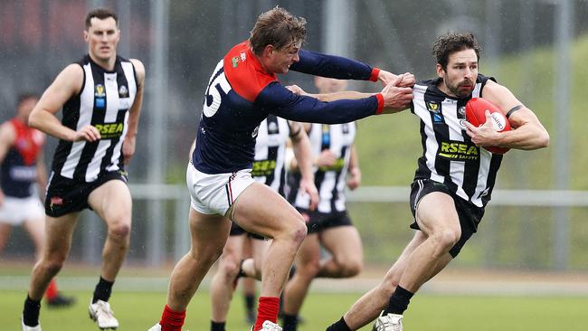 Round 6 TSL match between Glenorchy v North Hobart from KGV. Glenorchy's Sam Rundle palms off North Hobart's Jack Sandric. Picture: ZAK SIMMONDS