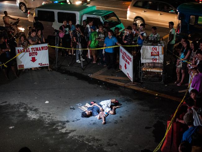 An alleged drug dealer and victim of a summary execution lies dead on a main throughfare in Manila. The victim was an alleged drug peddler, a claim disputed by his wife, who maintained her husband was nothing more than a pedicab driver plying his trade when he was shot in front of her. Picture: Getty Images