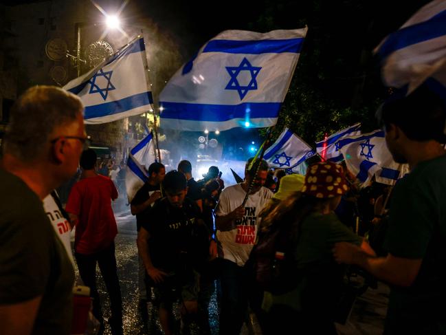 Israeli police use water canon to disperse protesters near the residence of the Israeli prime minister during an anti-government rally calling. Picture: AFP