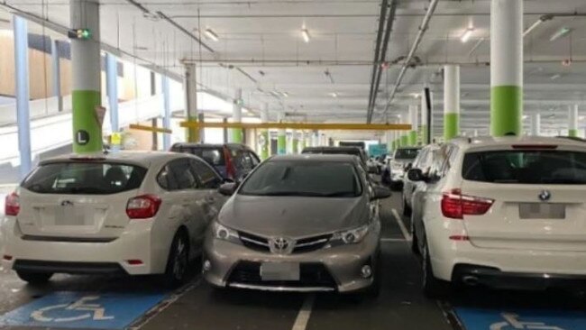 This driver was slammed online for parking between two cars parked in disabled bays in Westfield Eastgardens, Sydney. Picture: Facebook