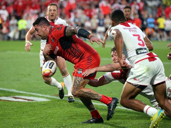 Tonga's Andrew Fifita loses the ball while scoring a try.