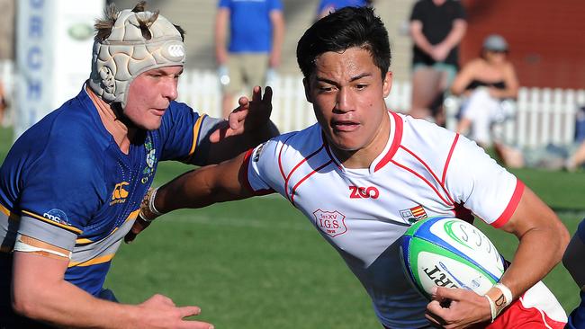 Kalani Thomas fends off his Churchie opponent will playing for Ipswich Grammar. Picture: John Gass