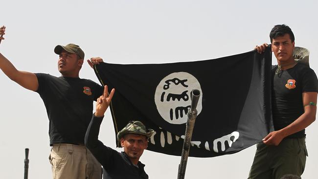 Shia fighters hold an Islamic State group after regaining the area from the militants in Saqlawiyah, near Fallujah.