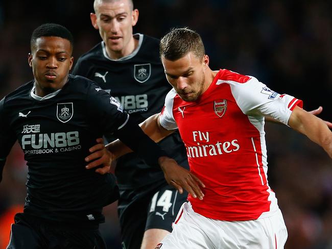 LONDON, ENGLAND - NOVEMBER 01: Lukas Podolski of Arsenal holds off Nathaniel Chalobah of Burnley during the Barclays Premier League match between Arsenal and Burnley at Emirates Stadium on November 1, 2014 in London, England. (Photo by Julian Finney/Getty Images)