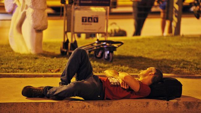 A passenger sleeps on the pavement outside Istanbul's Ataturk airport after the attack. Picture: Emrah Gurel/AP