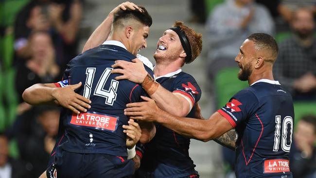 Jack Maddocks (left) in mobbed by teammates after scoring a try. Picture: AAP