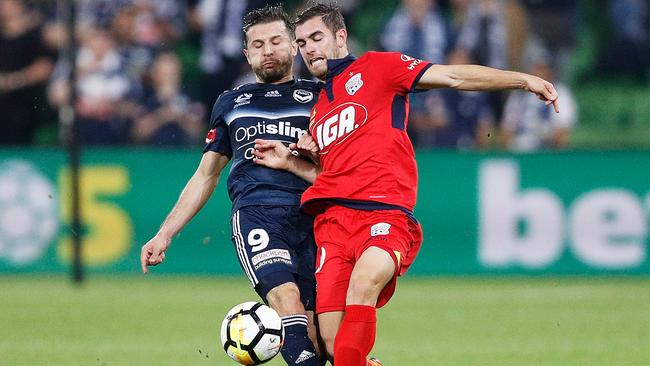 Kosta Barbarouses of the Victory and Ben Garuccio of Adelaide United in April. Picture: Getty Images