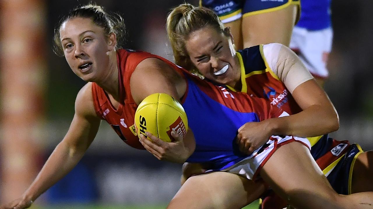 Tyla Hanks looks to handball after being tackled by Madison Newman. Picture: Mark Brake/Getty Images