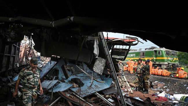 Military personnel at the accident site. Picture: AFP