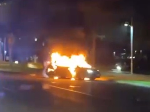 A screengrab from a video showing a Toyota Corolla well ablaze on The Strand in Townsville on Saturday night.