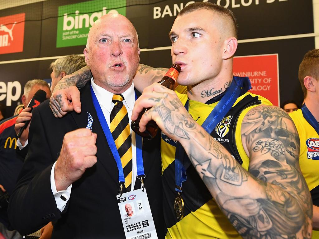 Dustin Martin of the Tigers celebrates in the rooms with Rex Hunt after winning the 2017 AFL Grand Final.