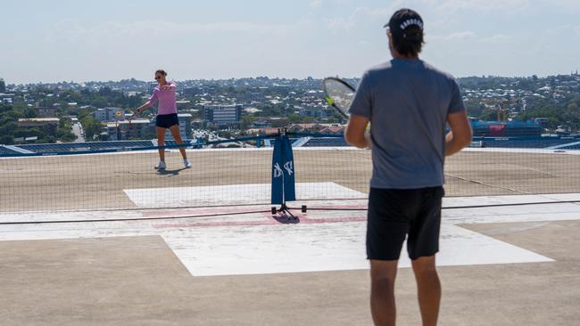 Two former world No. 1s Ash Barty and fellow Queenslander Pat Rafter during a rooftop tennis match to raise awareness and support for frontline healthcare workers during the Covid-19 pandemic.