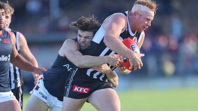 Norwood’s Nik Rokahr wraps up Port Adelaide’s Jake Weidemann in a tackle at Alberton Oval on Saturday. Picture: Cory Sutton