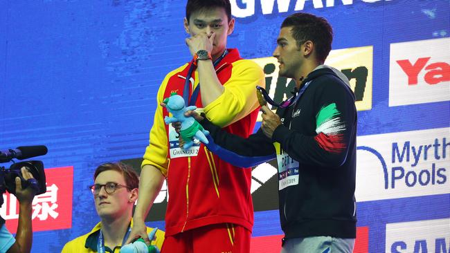 Mack Horton stands below the podium as Sun Yang receives his gold medal. Pic: Getty Images