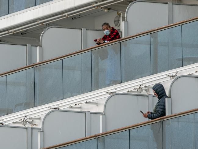 People stand on balconies on the Diamond Princess cruise ship while it is docked at Daikoku Pier. Picture: Getty Images