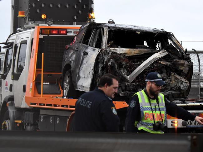 The charred Toyota Kluger is towed away from scene of a horrific three-vehicle crash. Picture: Matrix Pictures