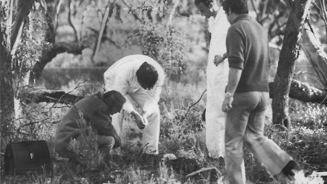 Dr Colin Manock, the director of forensic pathology, left, examines bones at the site of a second discovery of human remains at Truro, with other members of the SA forensic squad. Picture: The Advertiser