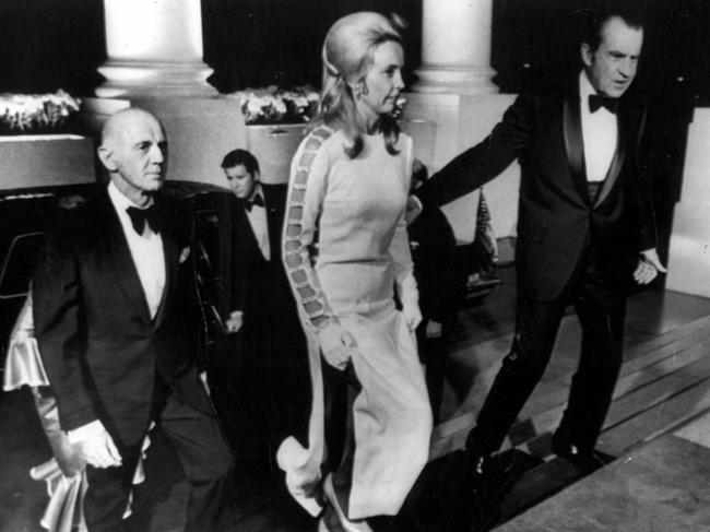 US president Richard Nixon escorts Sonia McMahon, wearing a famous split dress as husband, as Australian Prime Minister William McMahon follows, to function at White House. November 1971.