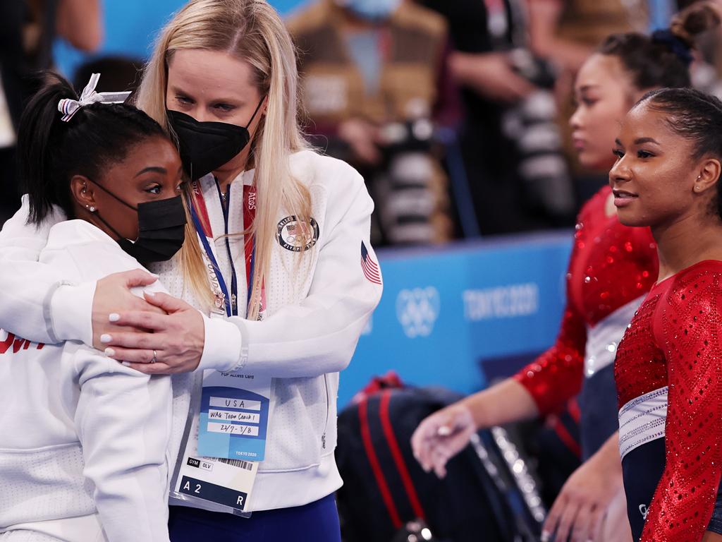 Simone Biles of Team United States is embraced by coach Cecile Landi during the Women's Team Final on day four of the Tokyo 2020 Olympic Game.