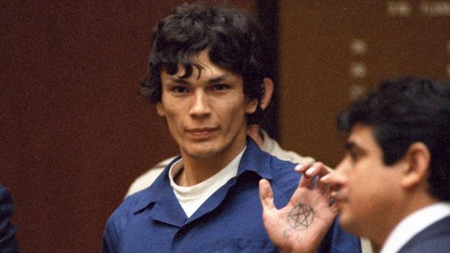 The ‘Night Stalker’ Richard Ramirez displays a pentagram symbol on his hand inside a Los Angeles courtroom in 1985. He was convicted of 13 murders but is believed to have committed many more. Picture: AP /Lennox McLendon.