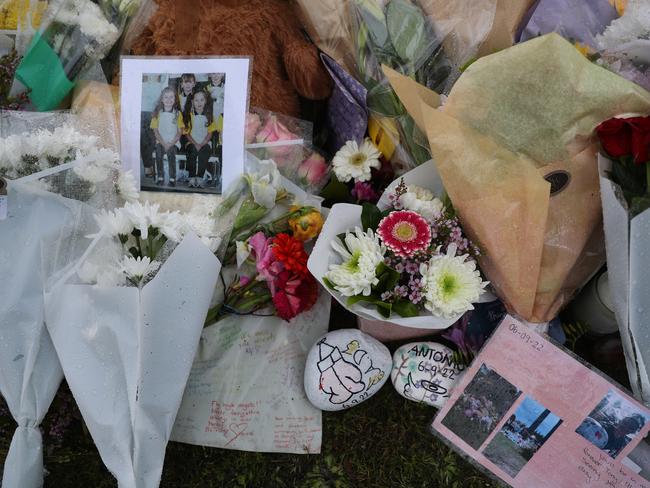 Photos, memorial stones and flowers at the tribute site. Picture: John Grainger