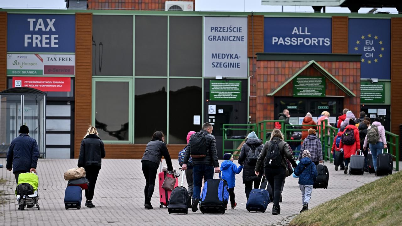 People pass through Medyka border crossing in Poland heading back into Ukraine on April 06, 2022. Photo Credit: Jeff J Mitchell/Getty Images.