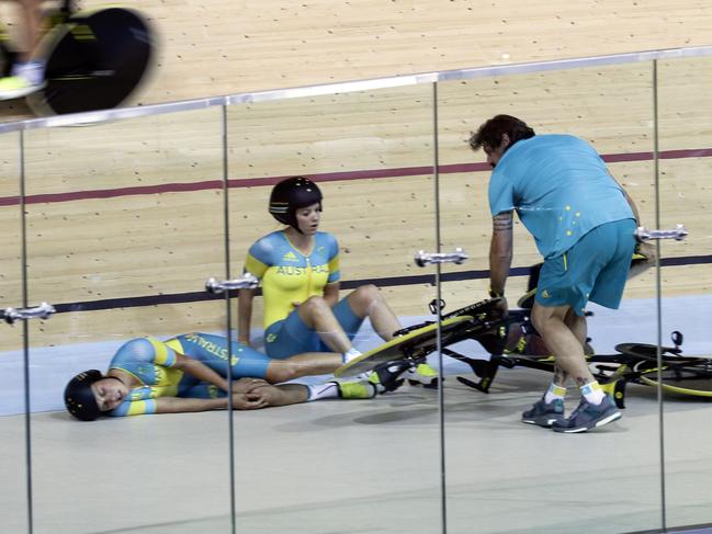 Officials come to the aid of Melissa Hoskins, left, and Amy Cure after the crash. Picture: AP