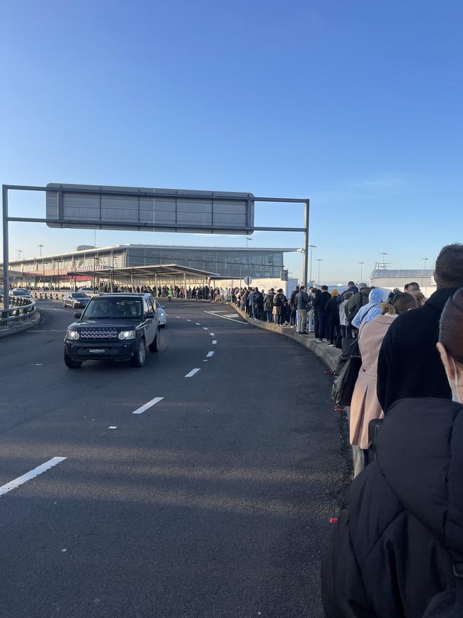Passengers are forced to queue outside the Virgin, Jetstar and Rex terminal at Sydney Airport due to delays on Monday morning. Picture: Twitter