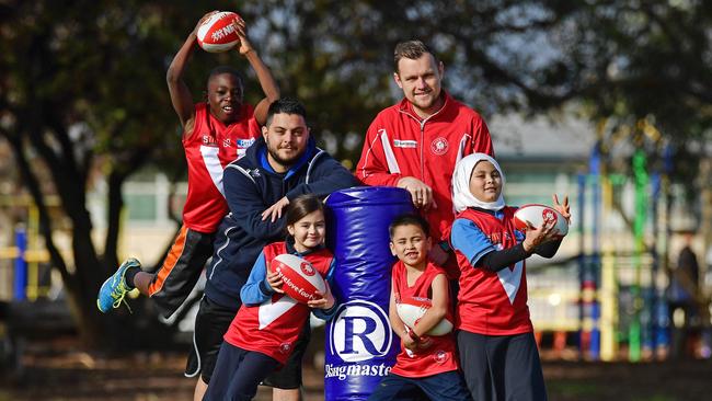 Pinnacle College students Mohammed, Shawqy, Fyzan and Zeenat with teacher Michael Triantafilakis and North Adelaide player Jason Rivett. The school is another which has previously taken part in the football program. Picture: Tom Huntley