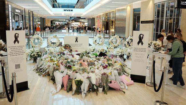 People at the flower tribute inside Westfield Bondi Junction one week after the horrific stabbing attacks. Picture: Tim Hunter