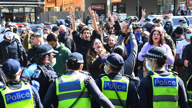 Anti-lockdown protesters face off with poilice at Melbourne's Queen Victoria Market during a rally on Sunday. PIcture: AFP