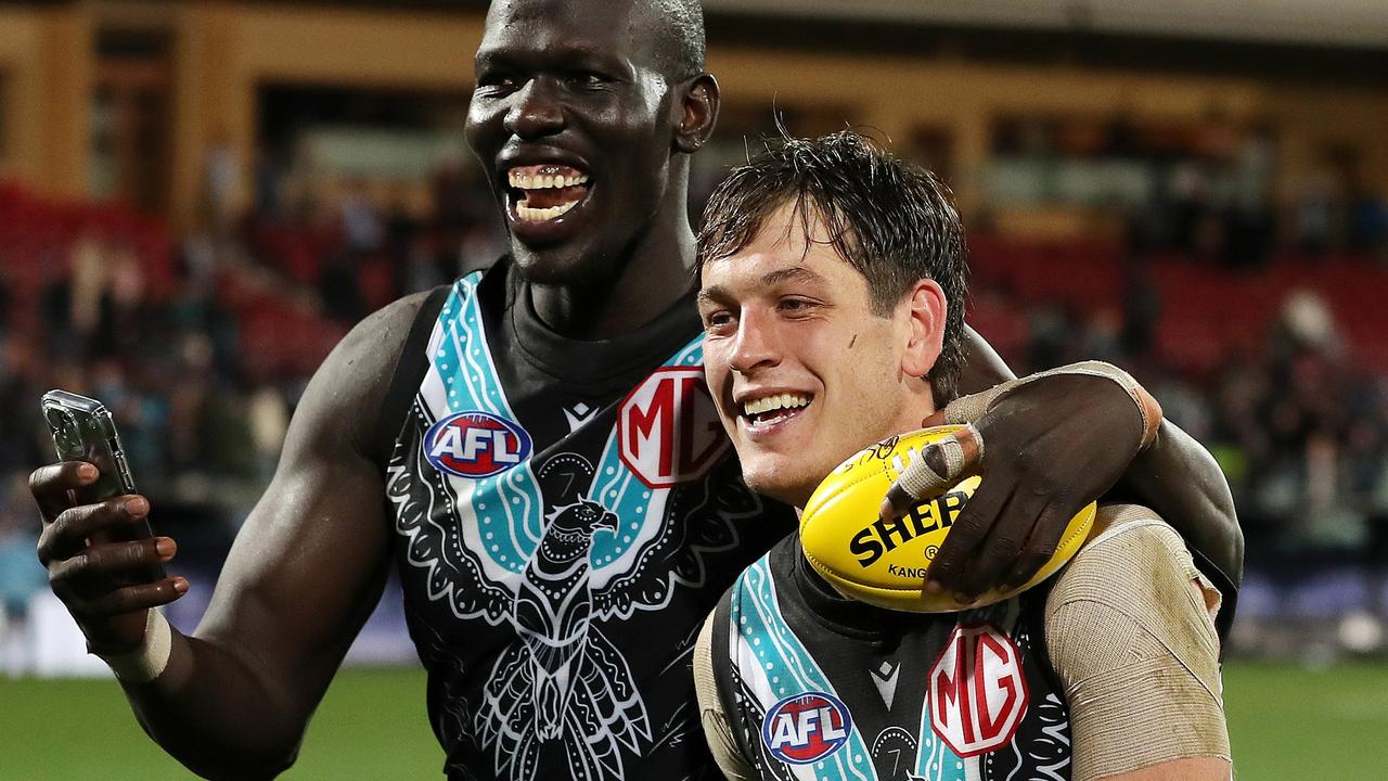 Aliir Aliir leaves the field with Zak Butters after the win over Melbourne. Picture: Sarah Reed