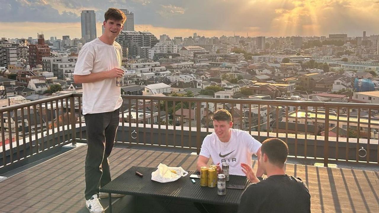 Paddy Dow, Sam Walsh and Adam Cerra take in a Tokyo sunset.